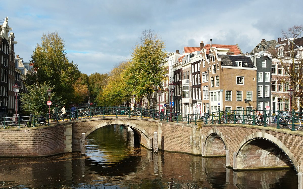 Historic Amsterdam canal bridge and traditional residential canal houses