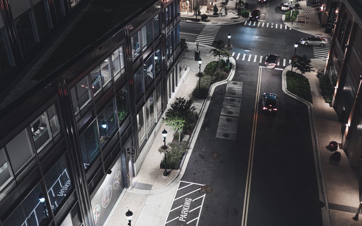 City street traffic, illuminated buildings, and crosswalks at night